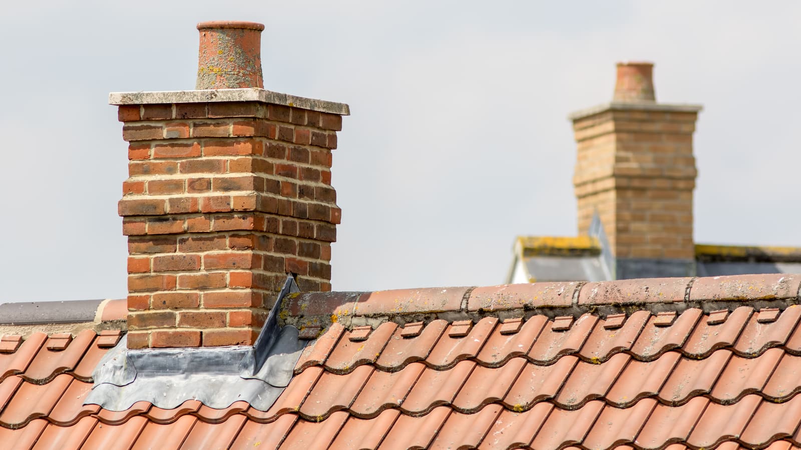 Brick chimney stack on a tiled roof